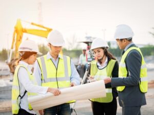 Construction professionals reviewing plans on an active project site in Newnan, GA.